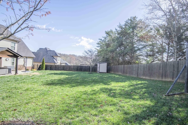 1312 Fox Ridge Dr, Powell, TN 37849 - view of yard featuring an outdoor structure, a fenced backyard, a shed, and a patio