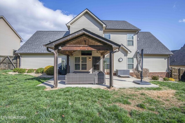 1312 Fox Ridge Dr, Powell, TN 37849 - back of property with fence, a shingled roof, a lawn, and a patio area