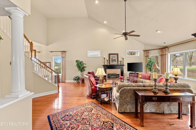 725 Wood Duck Dr, Vonore, TN 37885 - living area with stairway, high vaulted ceiling, ceiling fan, ornate columns, and wood finished floors