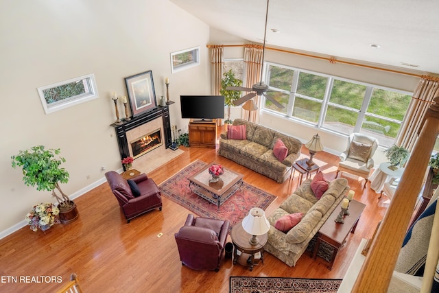 725 Wood Duck Dr, Vonore, TN 37885 - living area featuring lofted ceiling, wood finished floors, a ceiling fan, baseboards, and a fireplace