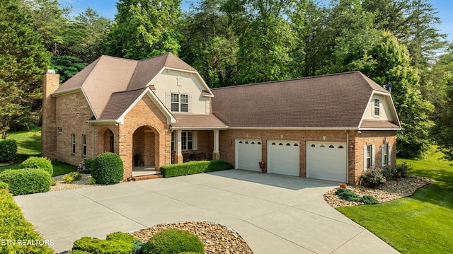 725 Wood Duck Dr, Vonore, TN 37885 - view of front of property with concrete driveway, brick siding, a garage, a front yard, and a porch