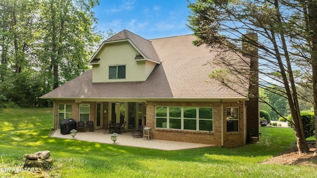 725 Wood Duck Dr, Vonore, TN 37885 - back of house with a lawn, a chimney, a patio area, and brick siding