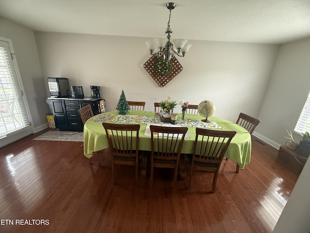 dining space with baseboards, a chandelier, dark wood-style floors, and a wealth of natural light