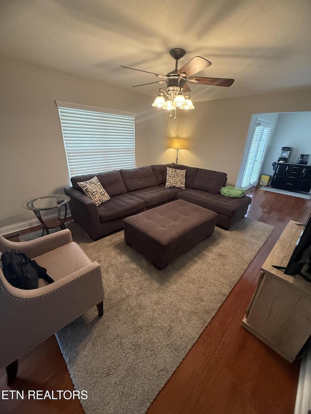 living area with ceiling fan and wood finished floors