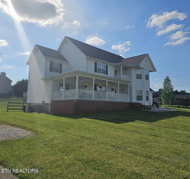 back of property featuring a porch and a yard