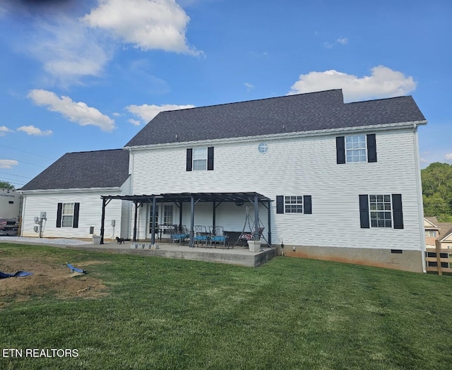 back of property featuring a lawn, crawl space, a shingled roof, and a patio area