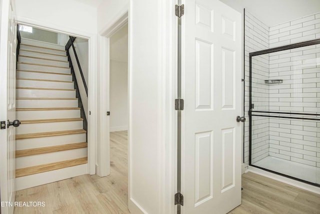 stairs featuring wood finished floors