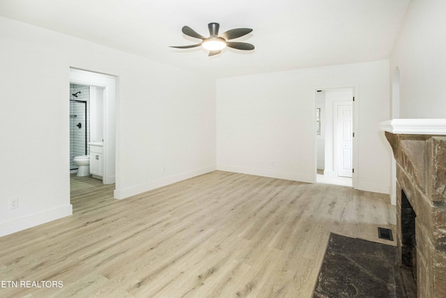 unfurnished living room featuring baseboards, ceiling fan, visible vents, and wood finished floors