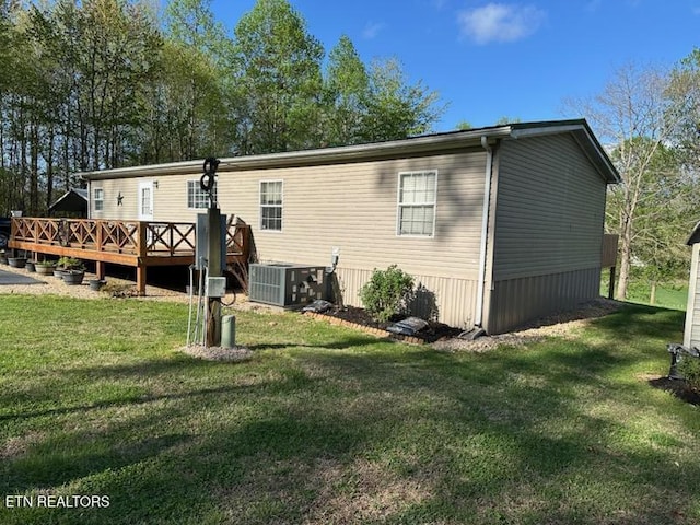 145 Liles Ln, Rocky Top, TN 37769 - rear view of property featuring cooling unit, a yard, and a deck