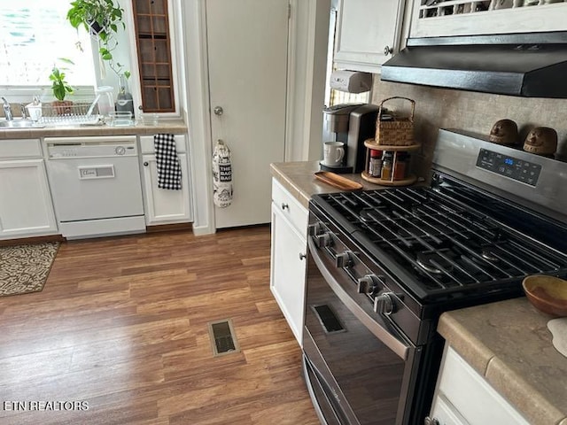 145 Liles Ln, Rocky Top, TN 37769 - kitchen with white cabinets, wood finished floors, light countertops, white dishwasher, and stainless steel gas range oven