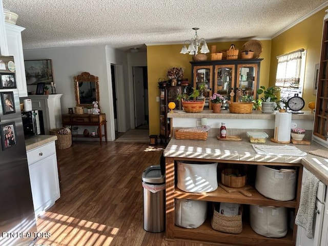 145 Liles Ln, Rocky Top, TN 37769 - dining space featuring a textured ceiling, an inviting chandelier, crown molding, and dark wood finished floors