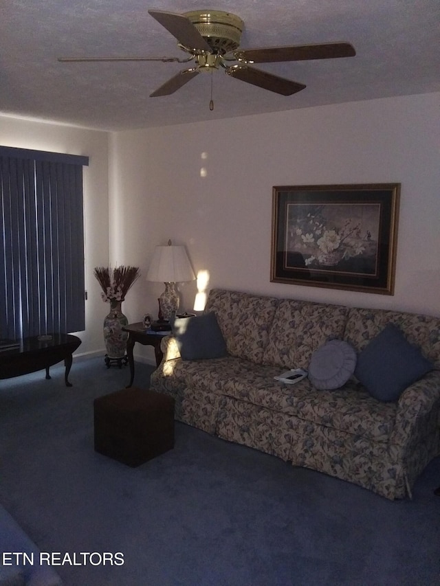 living area with a ceiling fan and carpet