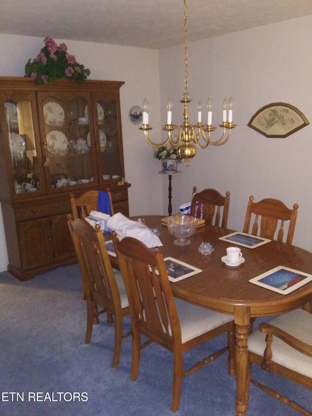 carpeted dining space with a chandelier