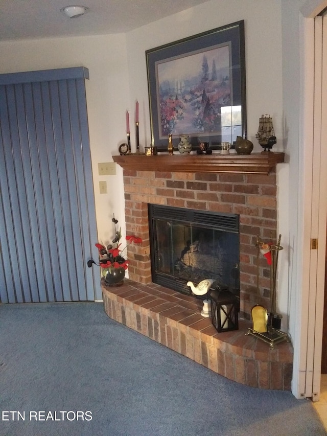 interior details with a fireplace and carpet flooring