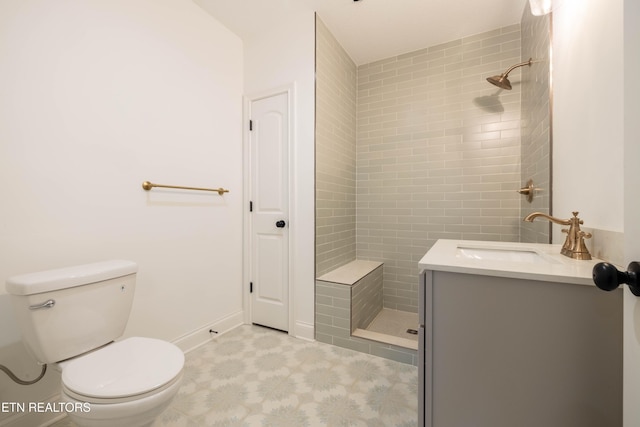 full bath featuring vanity, toilet, tile patterned floors, and tiled shower