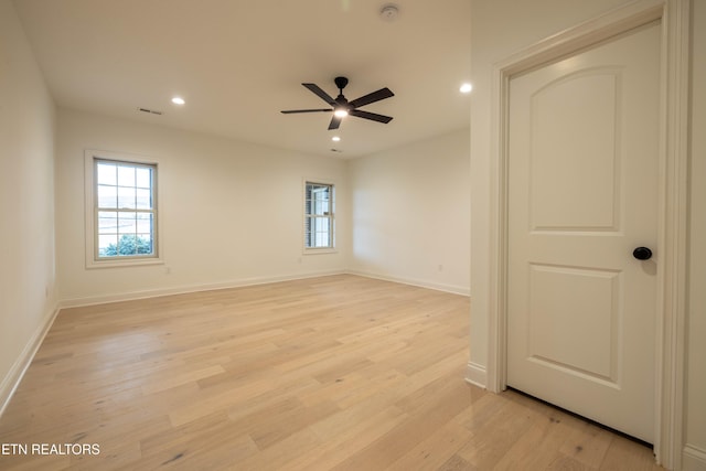 unfurnished room with baseboards, a wealth of natural light, recessed lighting, and light wood-type flooring