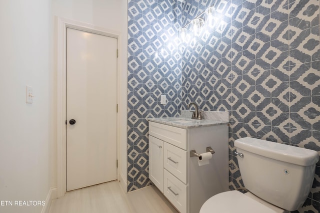 bathroom with toilet and vanity