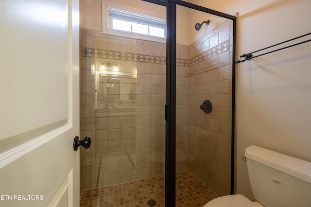 full bathroom with a shower stall and toilet