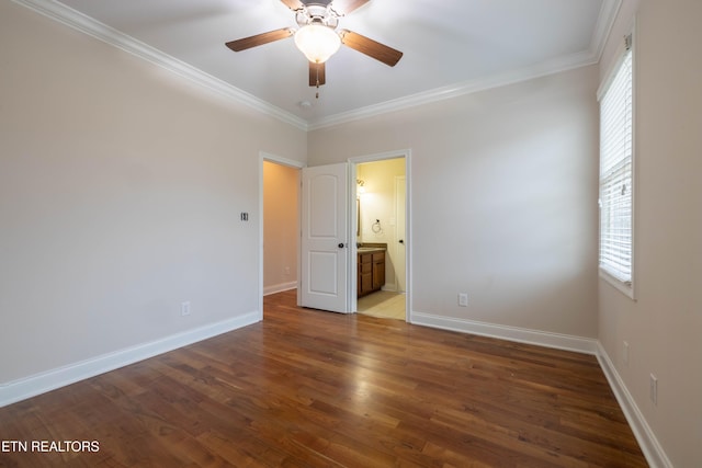 unfurnished bedroom featuring multiple windows, crown molding, and wood finished floors