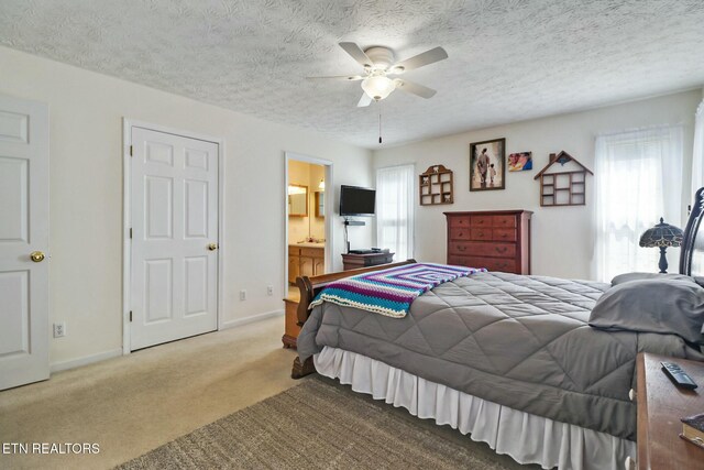 bedroom featuring ceiling fan, baseboards, carpet floors, and a textured ceiling