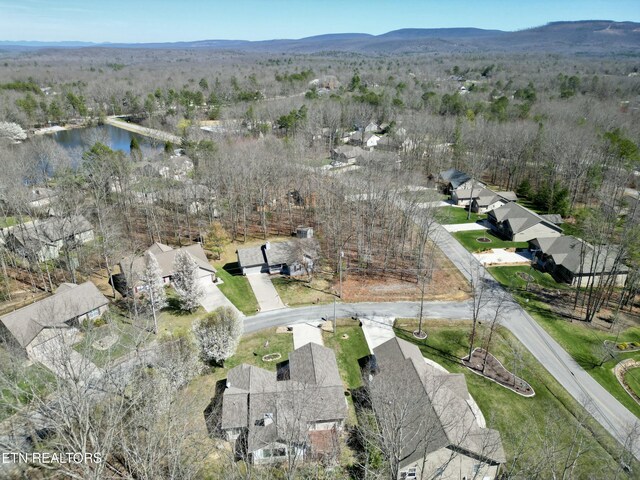drone / aerial view featuring a water and mountain view