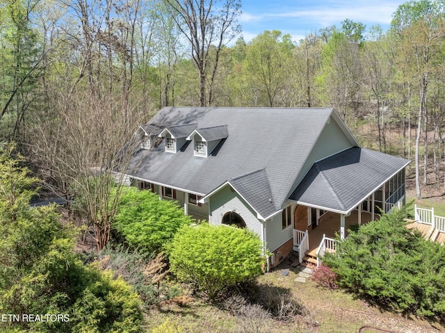 birds eye view of property featuring a view of trees