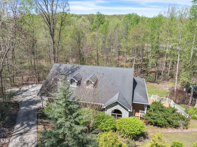 birds eye view of property with a forest view