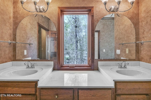 bathroom featuring vanity and a notable chandelier