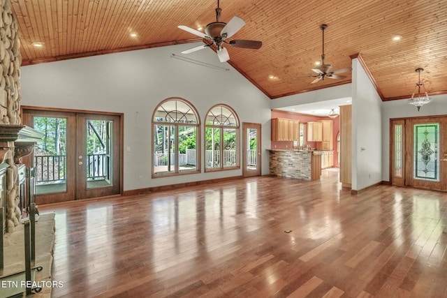 unfurnished living room featuring high vaulted ceiling, ornamental molding, a ceiling fan, wood ceiling, and wood finished floors