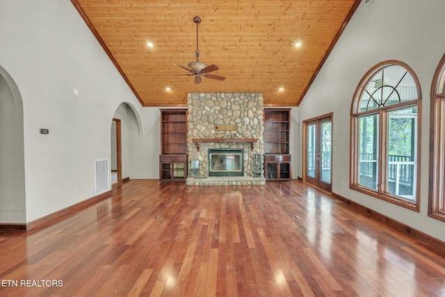 unfurnished living room with wood ceiling, high vaulted ceiling, ornamental molding, and visible vents