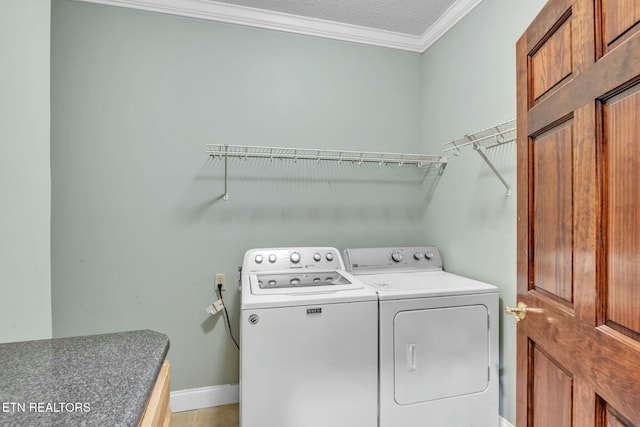 washroom with baseboards, separate washer and dryer, ornamental molding, laundry area, and a textured ceiling