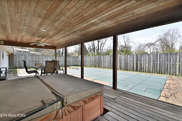 wooden deck with a fenced backyard, a patio, ceiling fan, and a hot tub