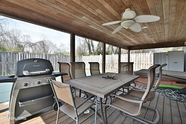 deck featuring area for grilling, a ceiling fan, and a fenced backyard