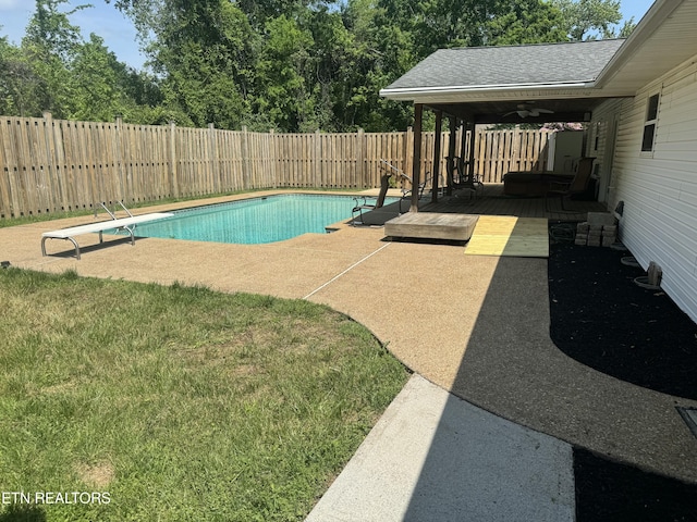 view of swimming pool with a deck, a fenced in pool, a fenced backyard, and a patio area