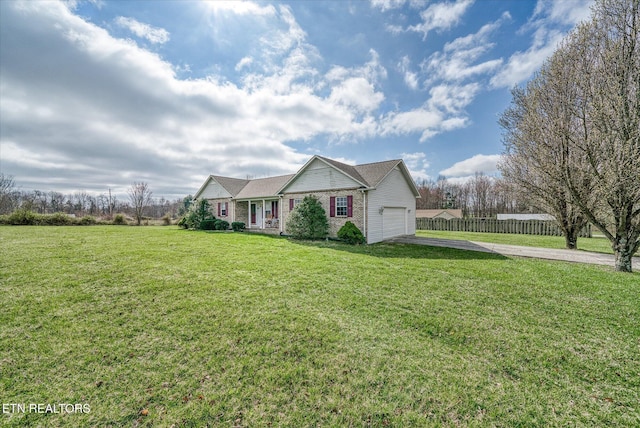 view of front of house with brick siding, a front lawn, fence, concrete driveway, and an attached garage