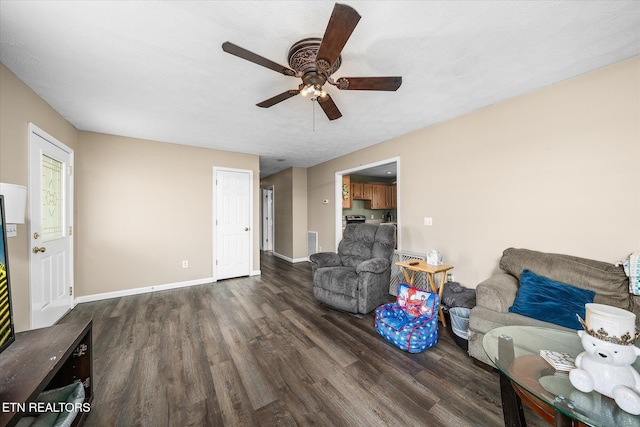 living area featuring visible vents, a textured ceiling, wood finished floors, baseboards, and ceiling fan