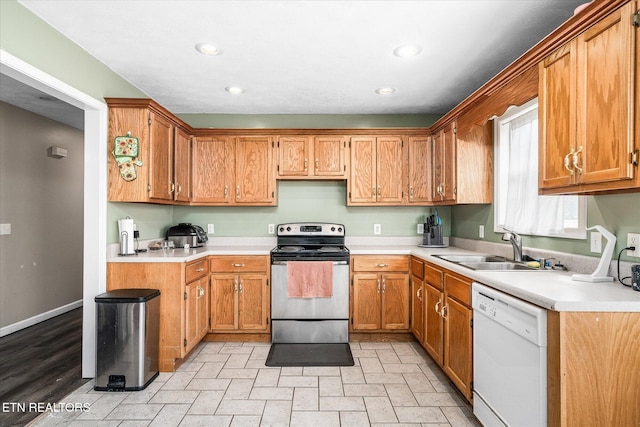 kitchen featuring dishwasher, stainless steel range with electric stovetop, recessed lighting, and a sink