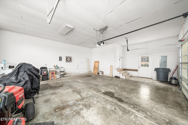 garage featuring electric panel and a garage door opener
