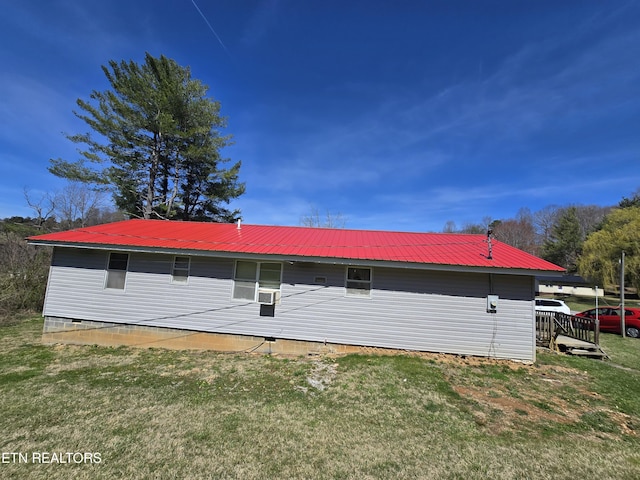 exterior space featuring a lawn and metal roof