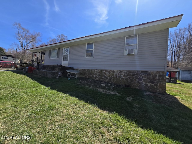 rear view of house with cooling unit and a yard