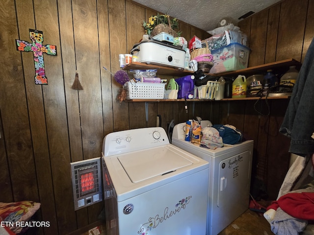laundry room with washing machine and clothes dryer, laundry area, and wood walls