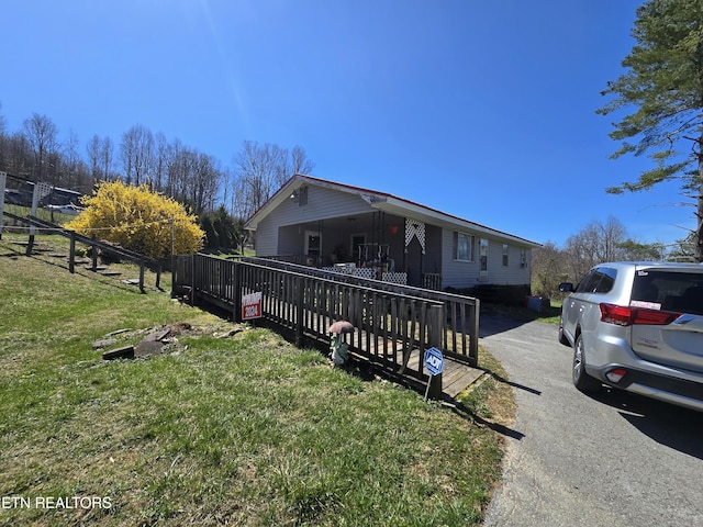 exterior space with driveway and a front yard