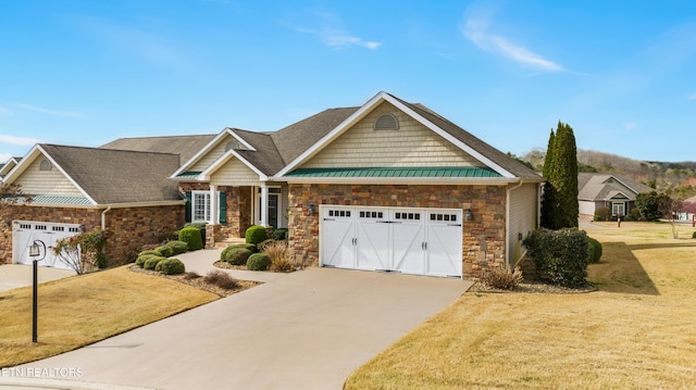 craftsman-style house featuring driveway, a standing seam roof, stone siding, metal roof, and a garage