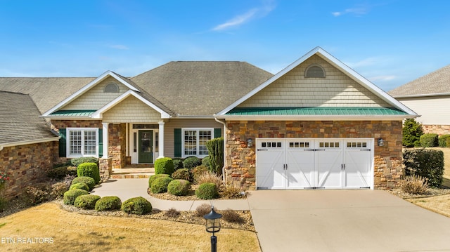 craftsman-style house featuring stone siding, concrete driveway, a garage, and a shingled roof