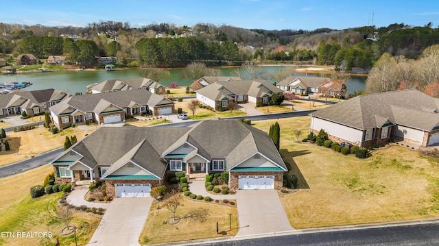 drone / aerial view featuring a residential view and a water view