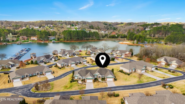 drone / aerial view featuring a residential view and a water view