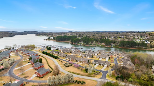 drone / aerial view with a water view and a residential view