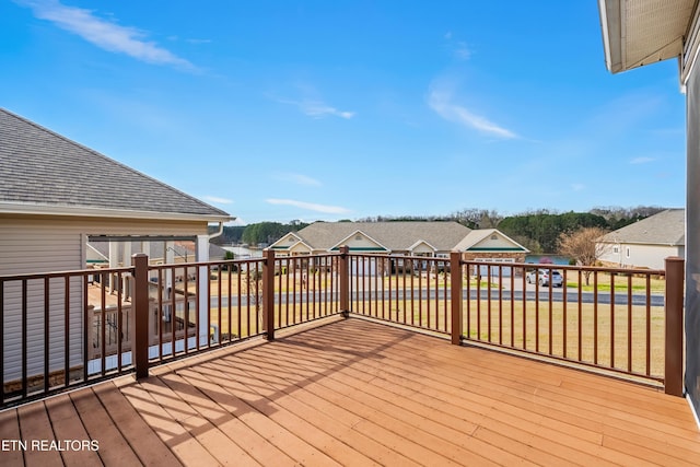 deck featuring a yard and a residential view