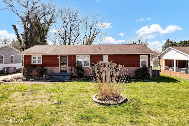 ranch-style house featuring a front yard, cooling unit, and fence