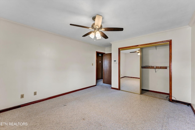 unfurnished bedroom with carpet floors, baseboards, a closet, and ornamental molding